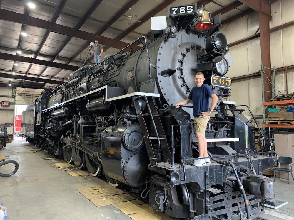 Two individual poses on steam locomotive. 