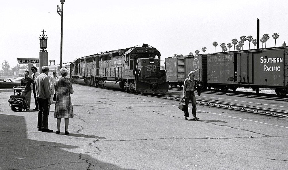 black and white train with people nearby