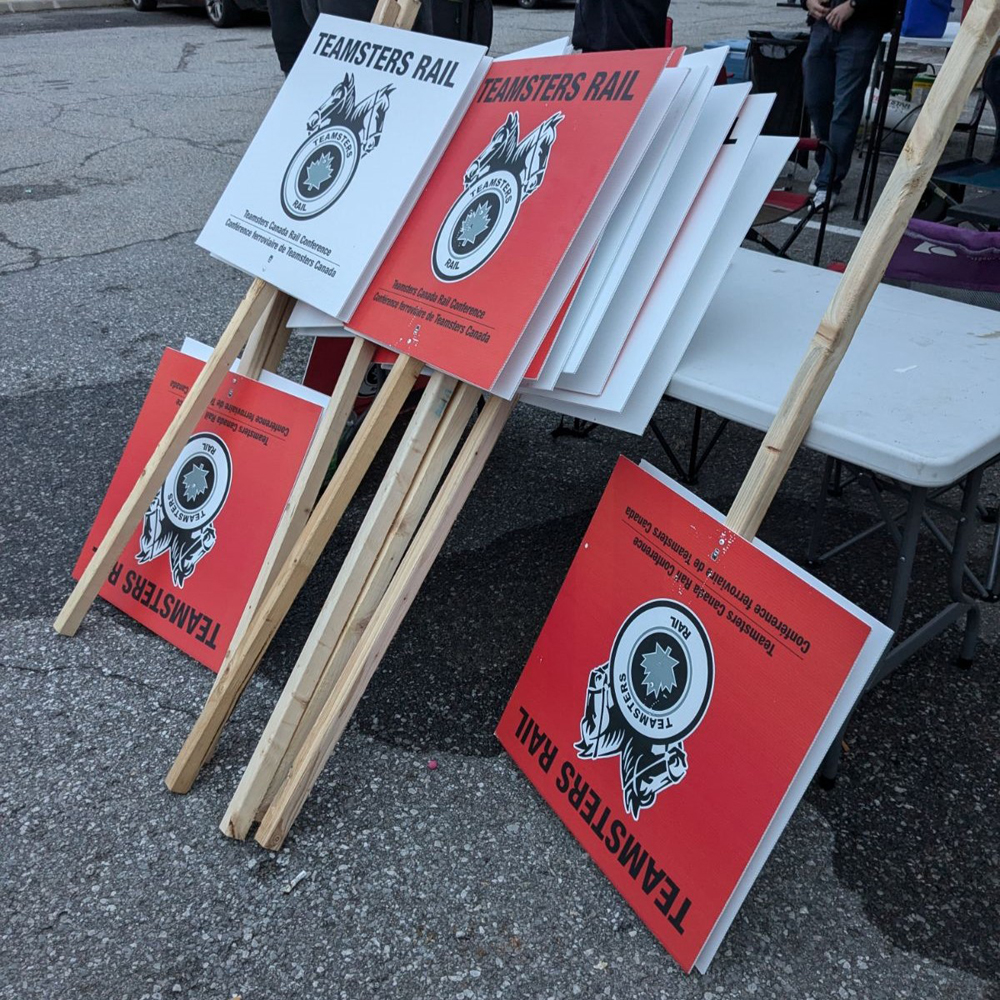 Red and white picket signs leaning against table