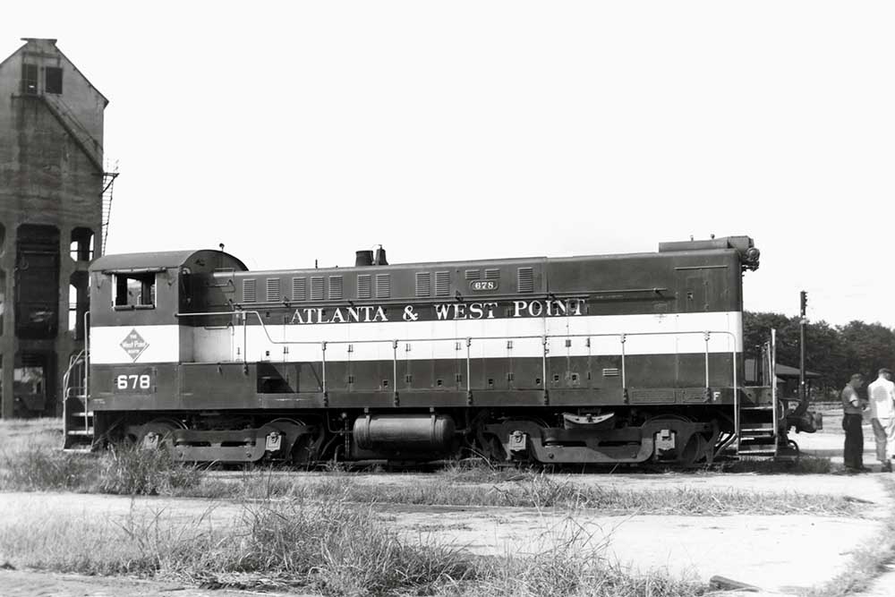 End-cab diesel Atlanta & West Point locomotives resting by coaling tower