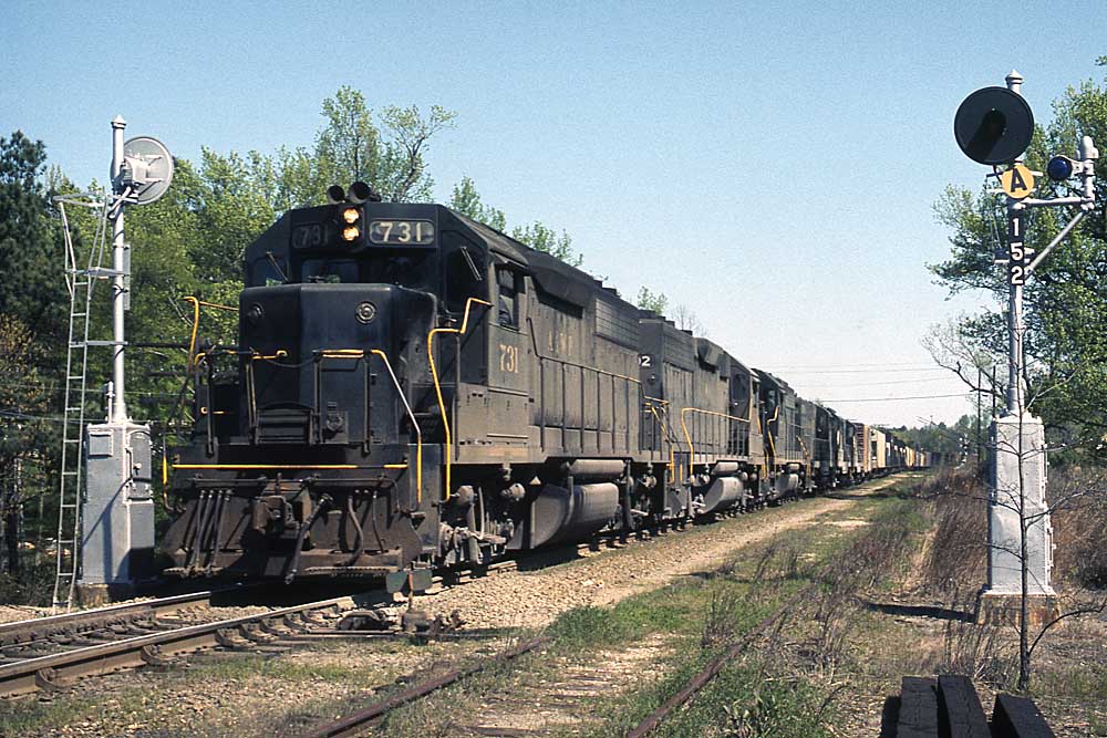 Black diesel Atlanta & West Point locomotives with freight train between signals