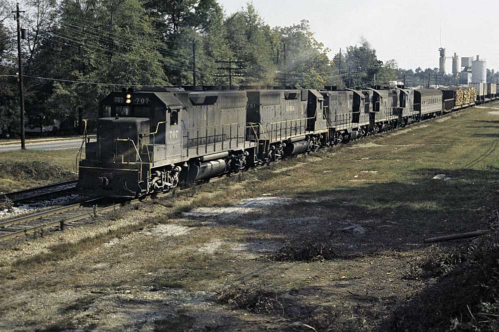 Five black diesel Atlanta & West Point locomotives with train