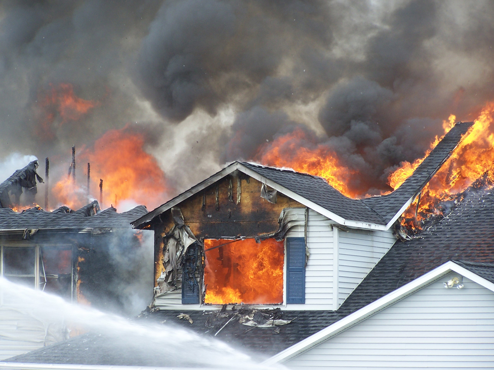 Color photo showing house on fire.