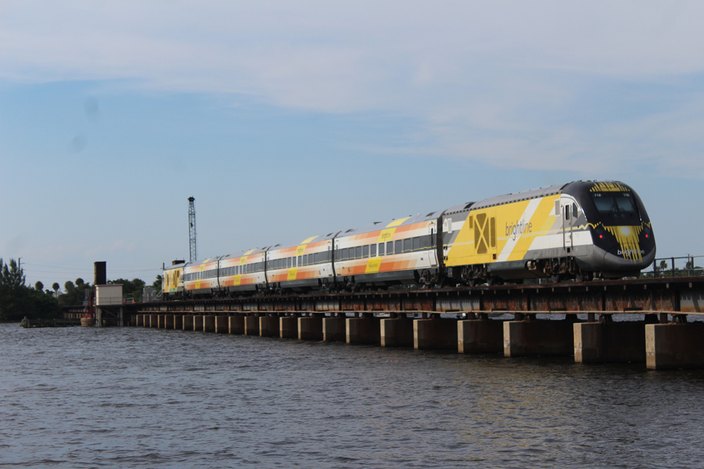 Brightline train on track over river