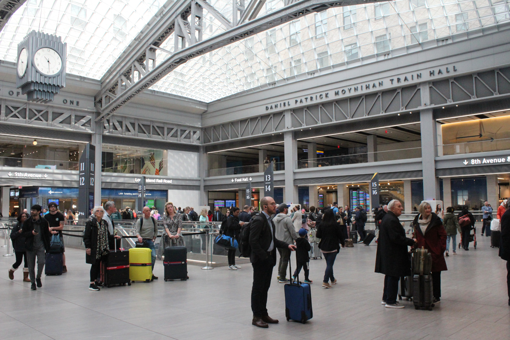 People in large, open area of passenger train station