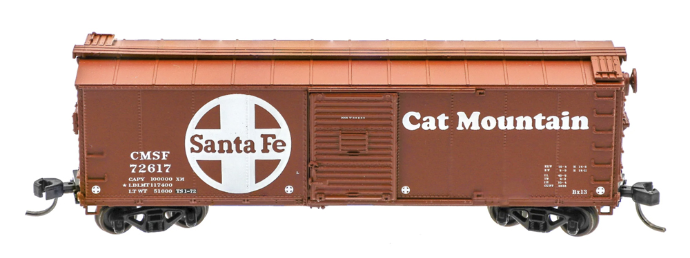 A brown model freight car with white lettering