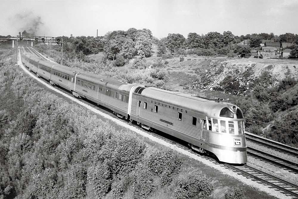 Streamlined Burlington Route diesel locomotives on curve with passenger train