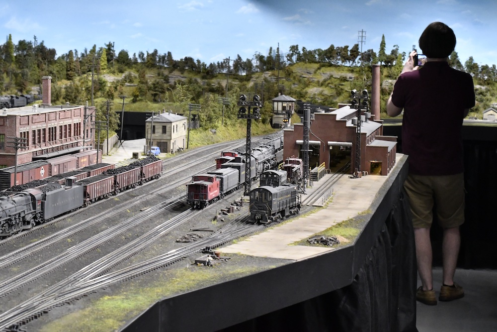 model train layout with person in the background