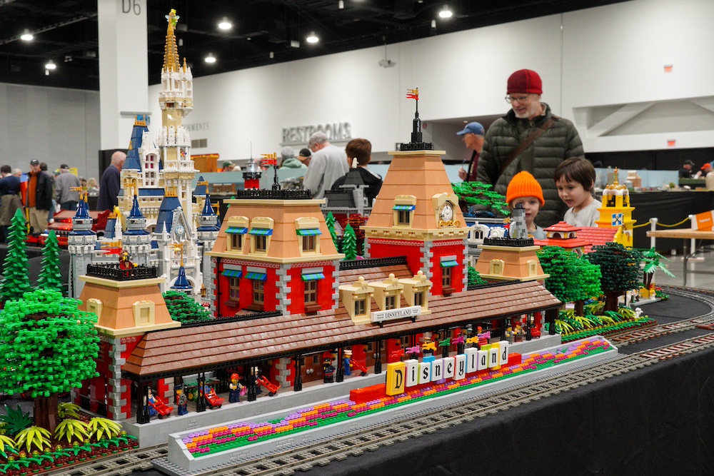 Lego display of train station and nearby castle