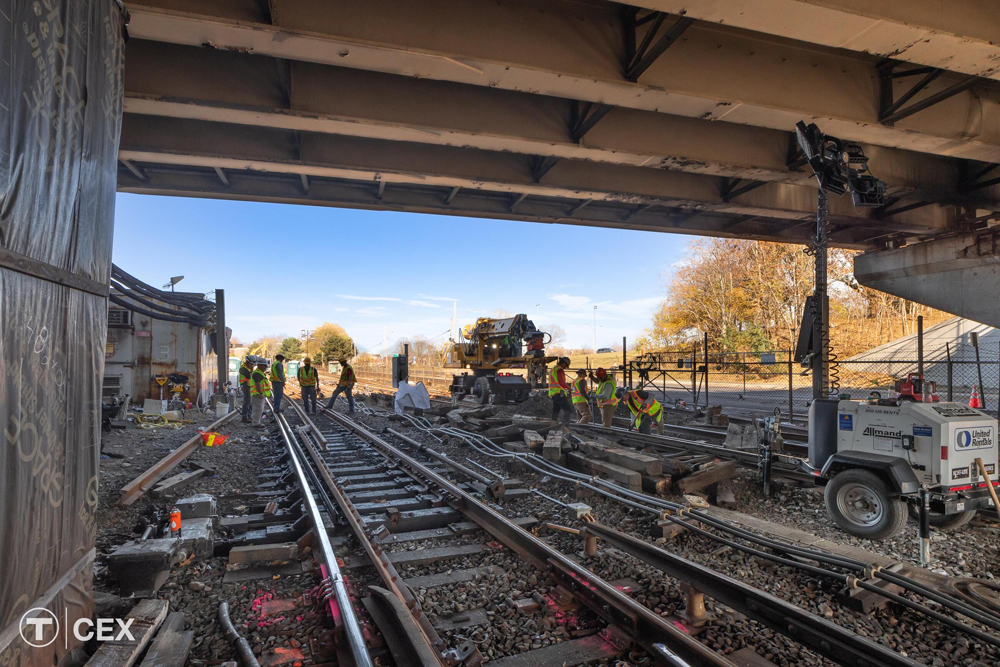 Maintenance crew working on track under bridge