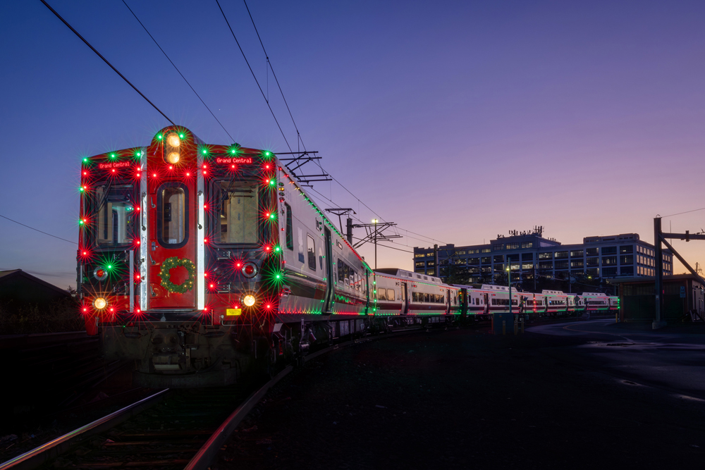 EMU trainset with holiday lights at sunset