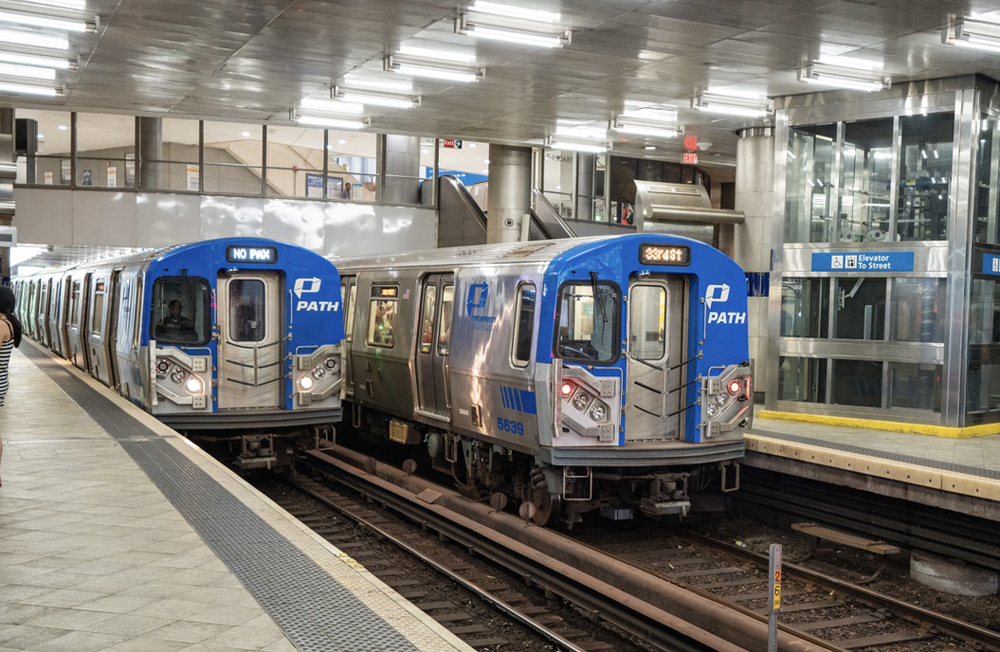 Two rapid-transit trainsets side by side at station