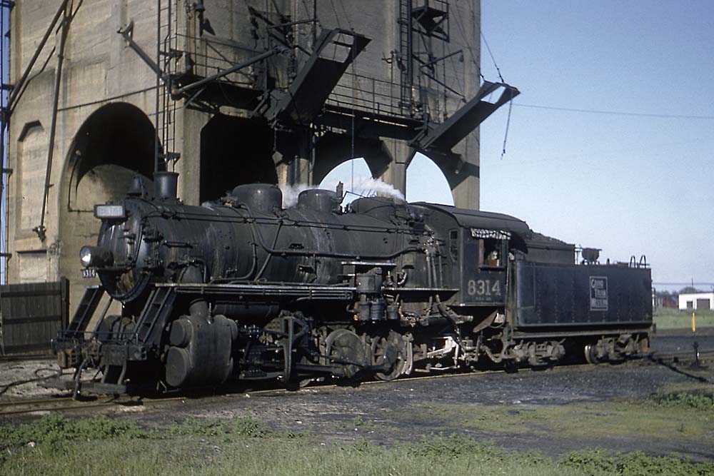 Grand Trunk Western steam locomotive beneath concrete coaling tower