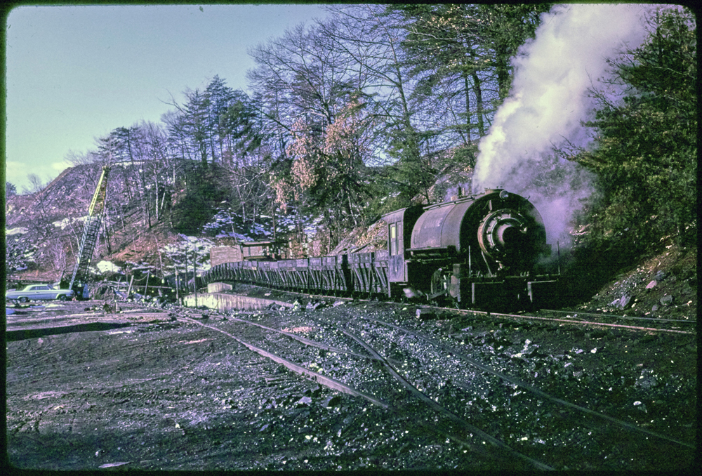 Tank steam engine moving gondola cars