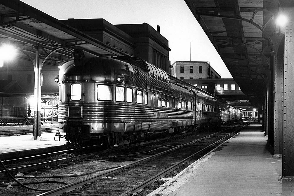 Streamlined stainless steel locomotives at station with platform canopies 