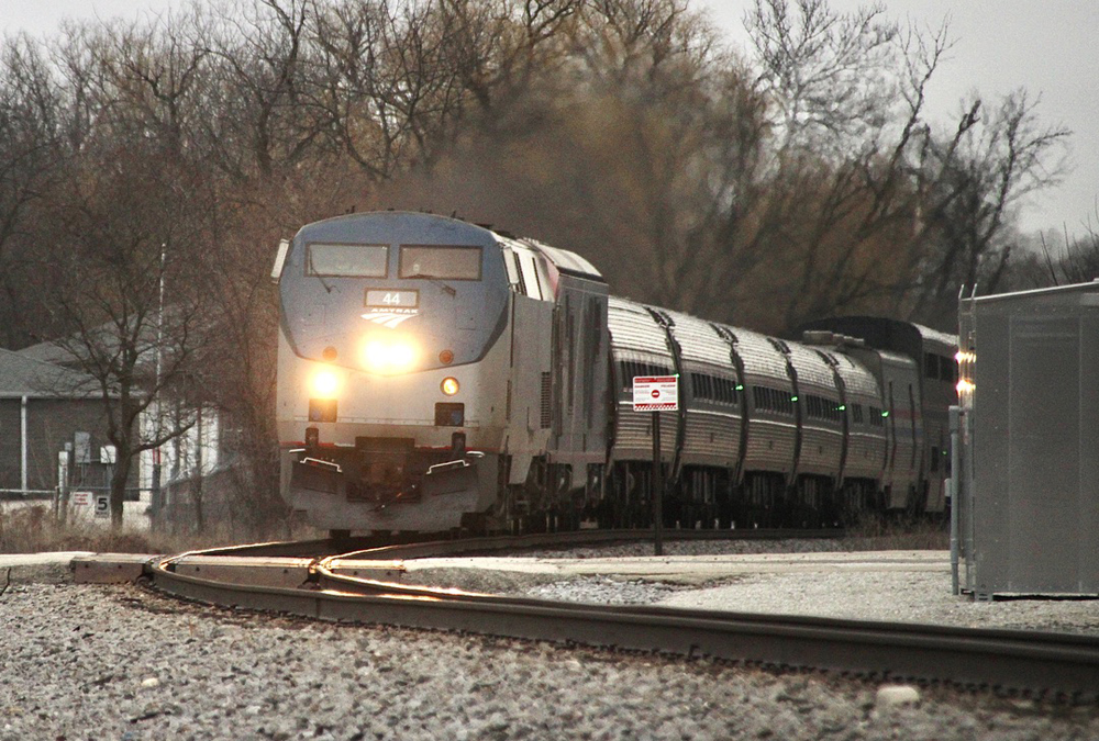 Passenger train with five deadlead cars behind locomotives
