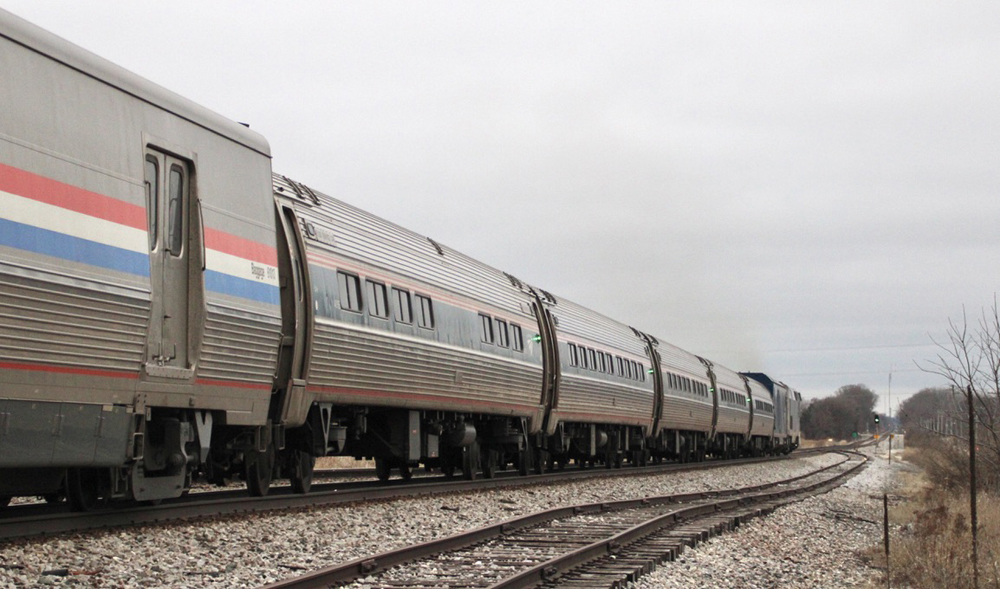 Going-away shot of single-level passenger cars ahead of baggage care on Empire Builder