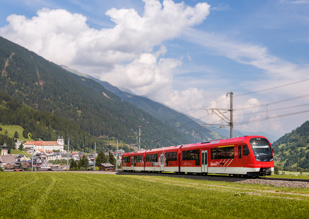 Red EMU trainset with Swiss village in background