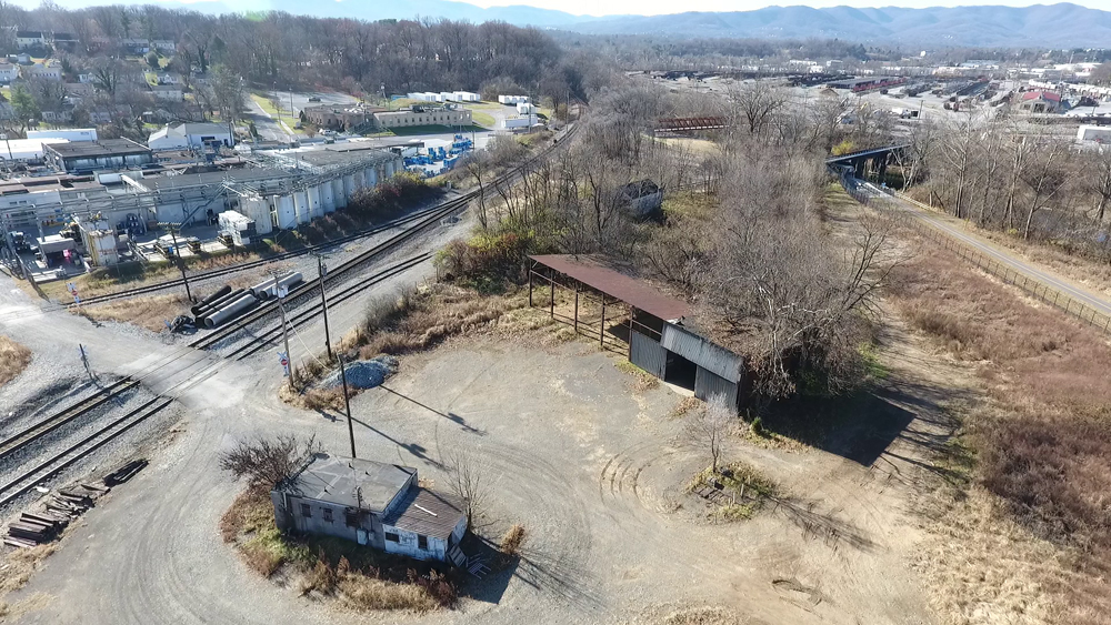 Aerial view of lot with several old, small buildings