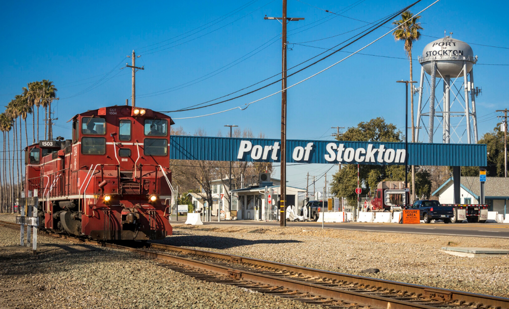 Two red end-cab switchers with "Port of Stockton" sign in background