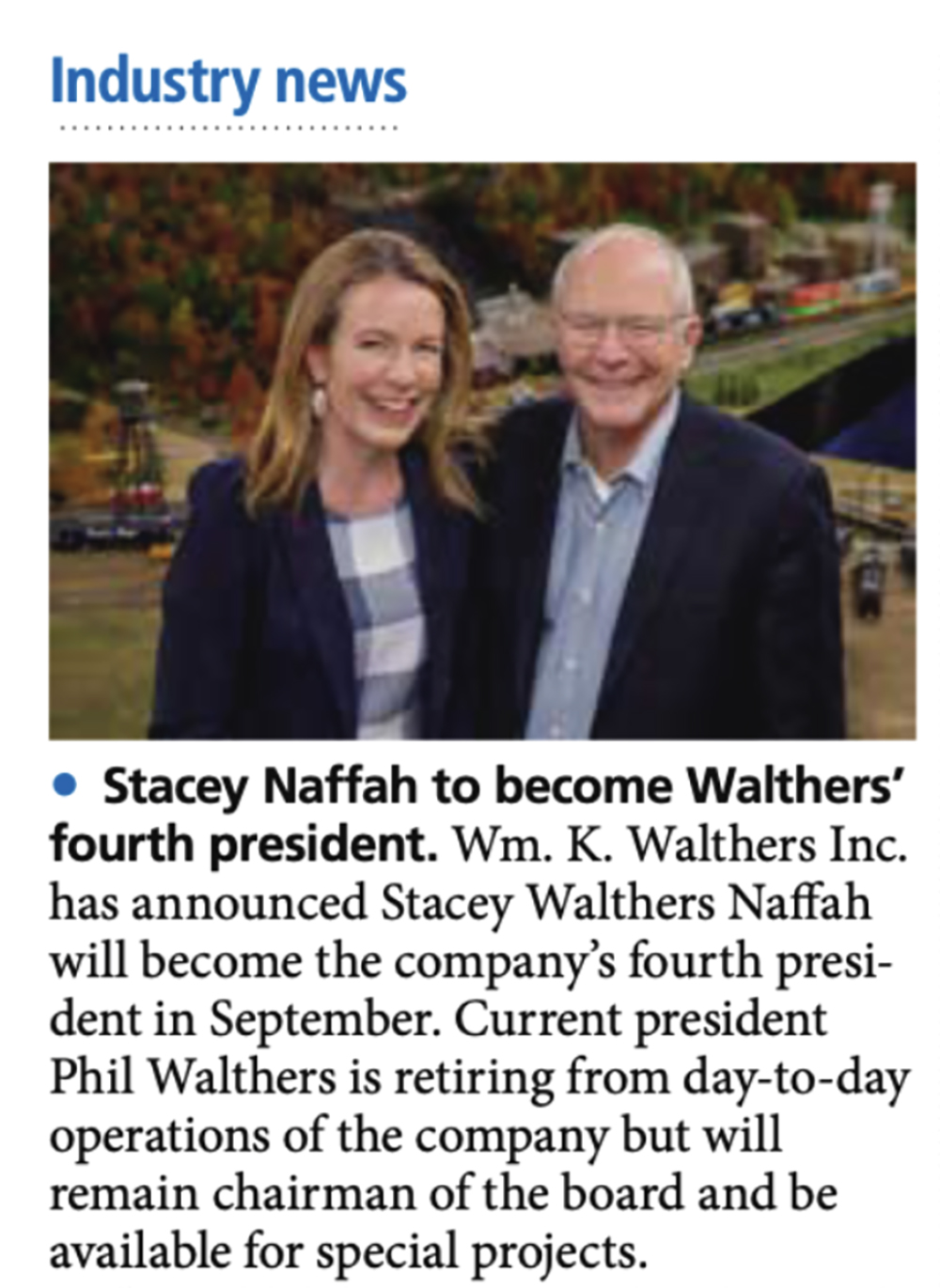 A magazine clipping with blue and black text, plus a photo of a woman and a man standing together and both wearing blue sport coats.