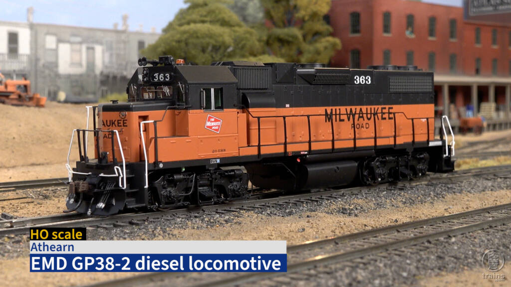 Screen capture of video with orange and black HO scale diesel and title bar in lower left corner.