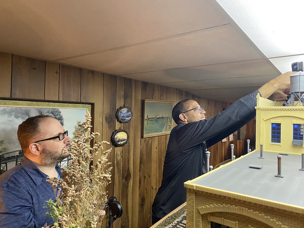 Two people set up a GoPro video camera.