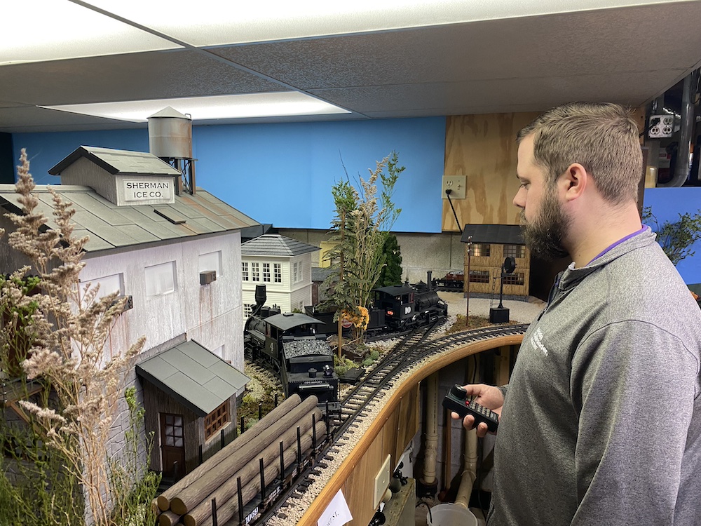 Operator runs a log train through a wye track