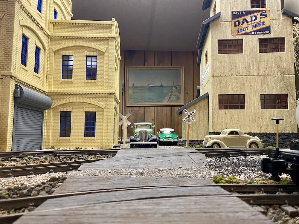 Front-facing photo of roadway between two scratch-built buildings