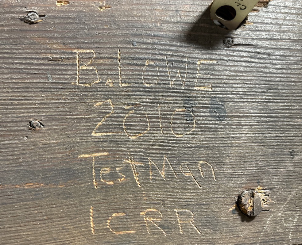 Words carved into wood in tower: "B. Lowe, 2010, Testman, ICRR"
