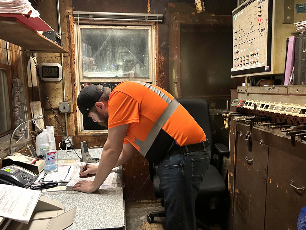 Man in hi-visibility orange shirt in tower