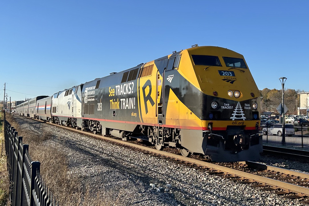 Black and yellow locomotive on passenger train