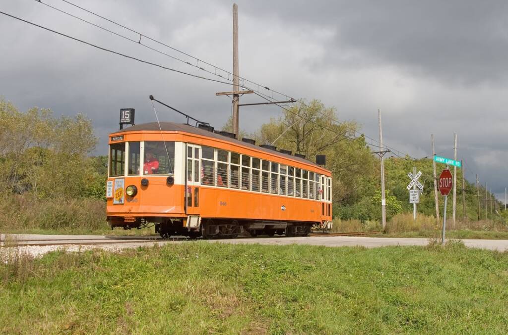 Orange trolley operates on a cloudy day