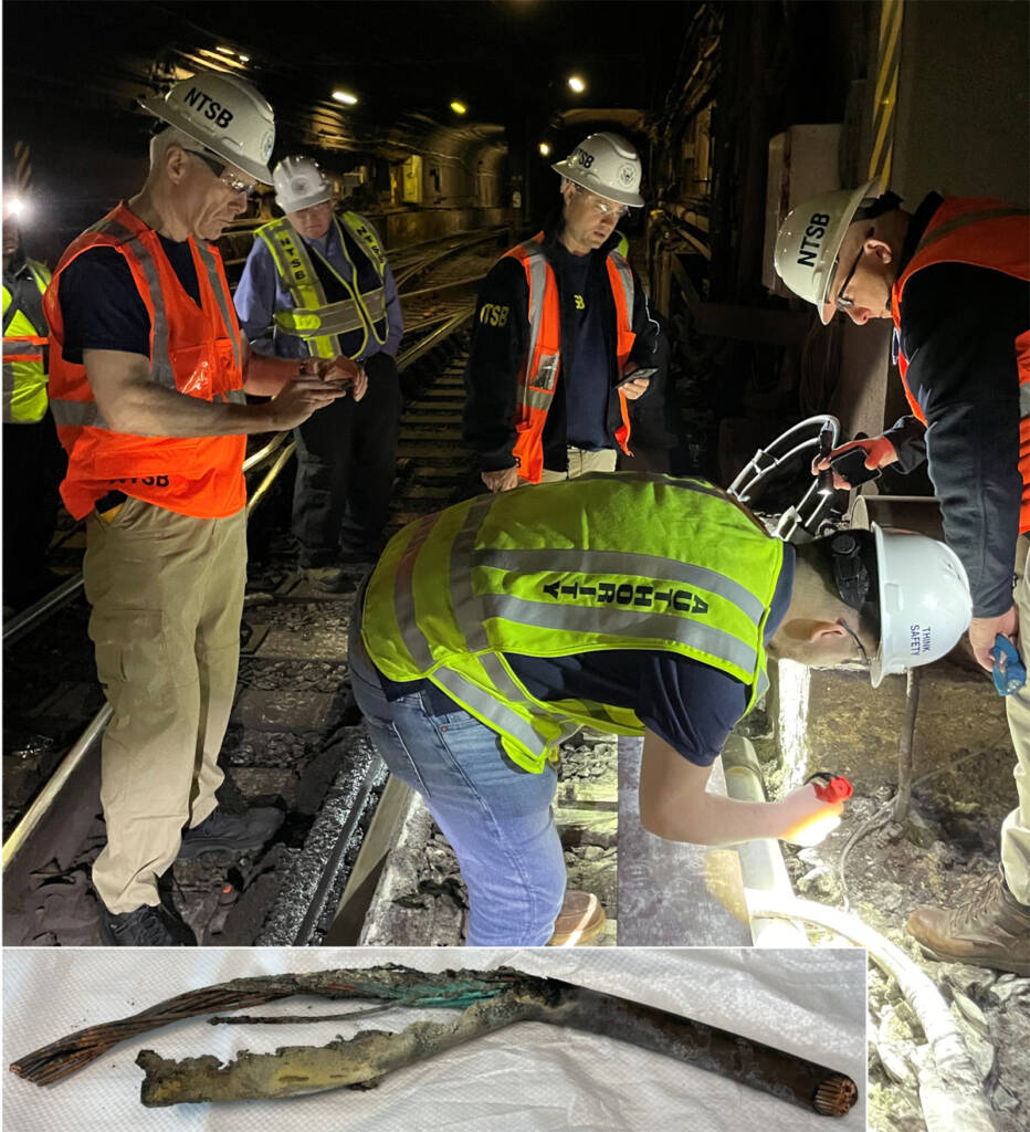 Men in safety gear examining area next to rail line