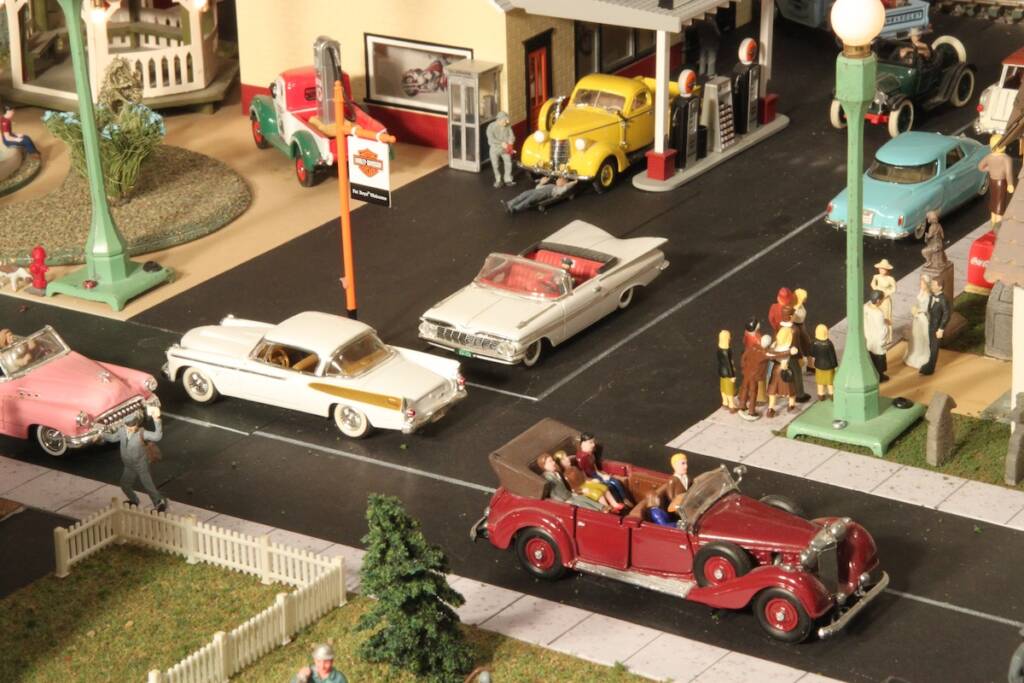 treet scene with cars on model train layout