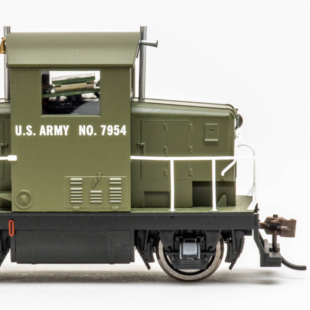Color photo HO scale diesel locomotive painted olive green and black on white background