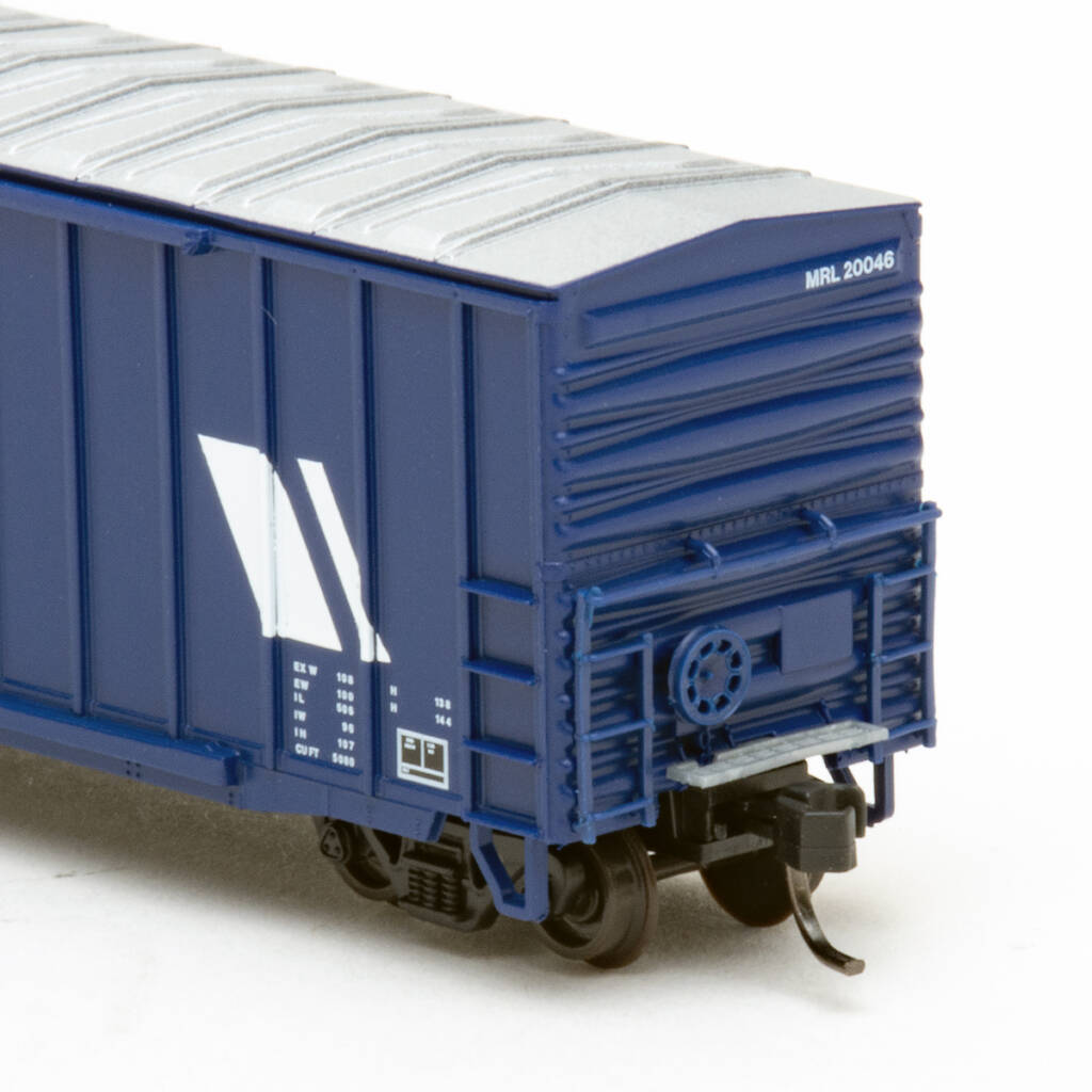 Color photo of N scale boxcar painted dark blue with aluminum roof and red and white graphics on white background