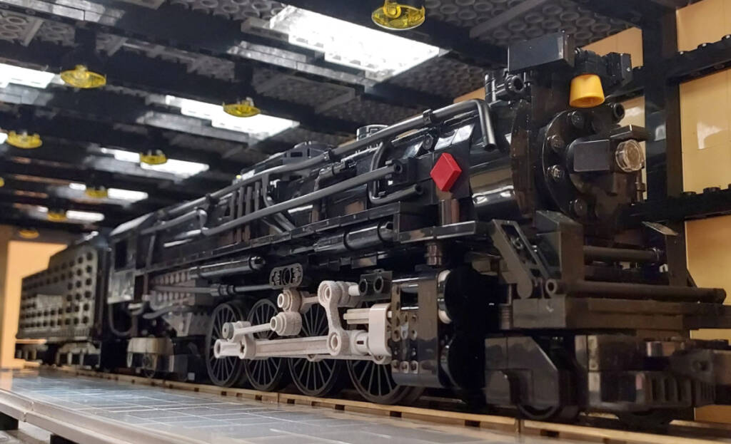 A black model locomotive made of Lego bricks
