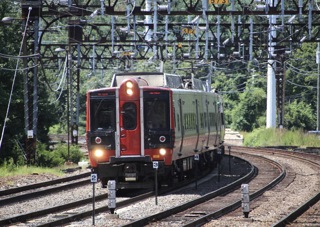 Electric multiple unit trainset with red front rounds curve