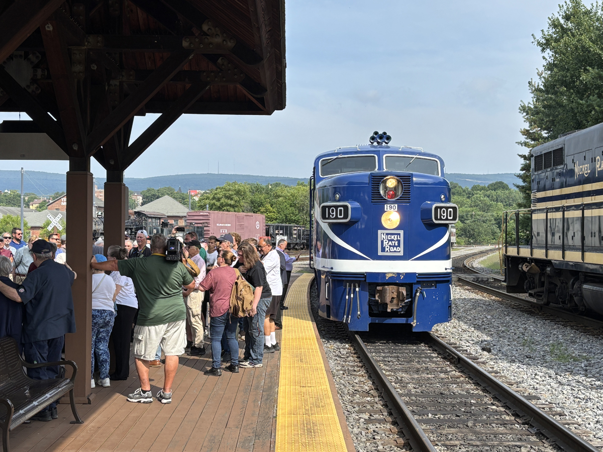 Blue and white diesel passenger loocomotive at station