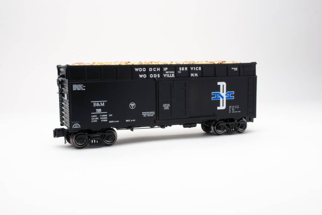 Black, white and blue wood-chip car