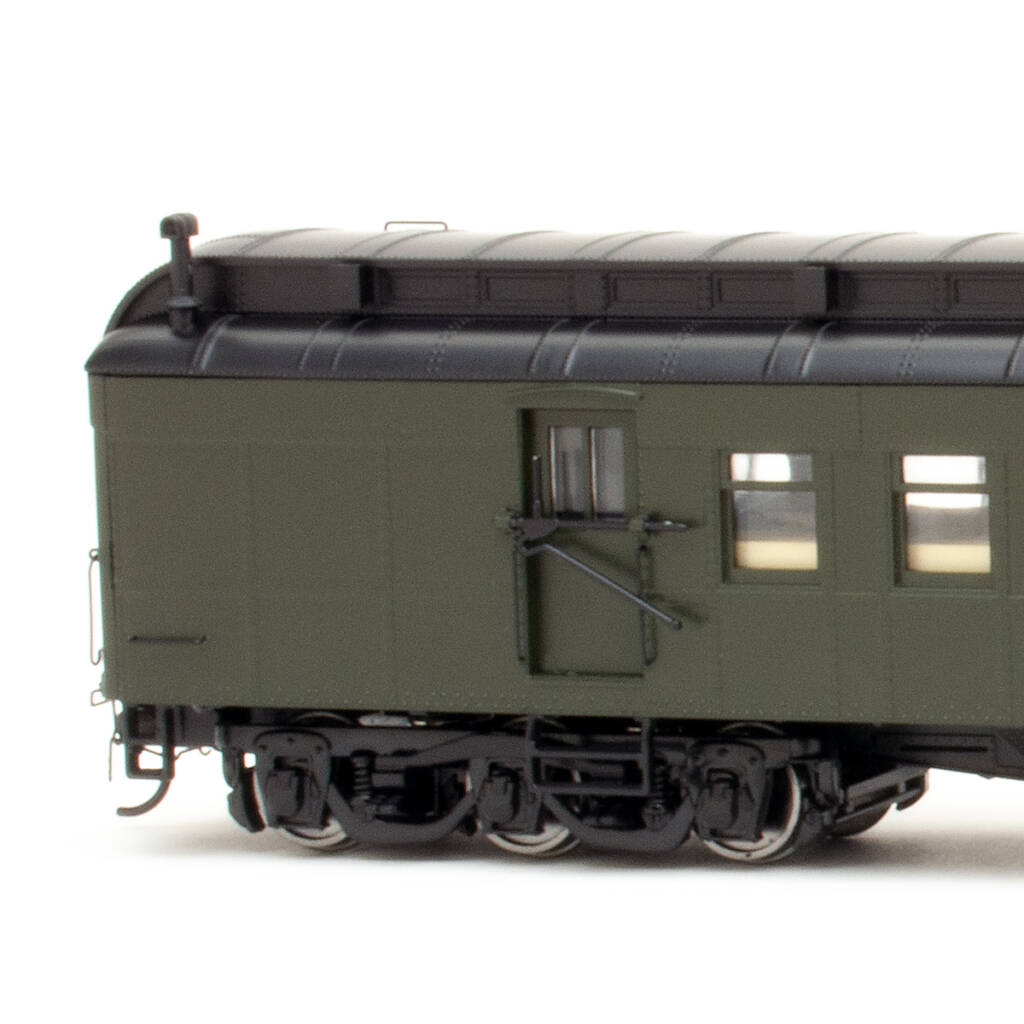 Color photo showing mail compartment end of HO scale 70-foot heavyweight RPO-baggage car with clerestory roof painted Pullman Green and black on white background
