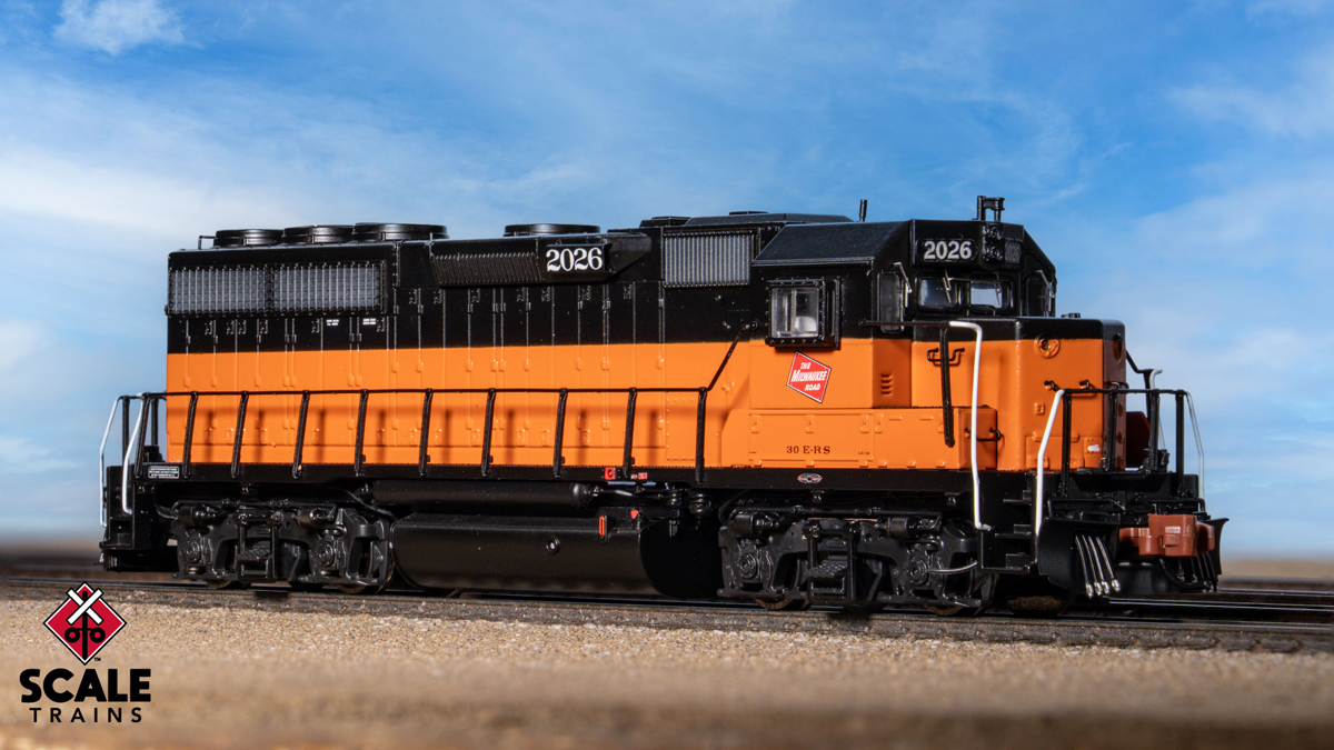 An orange and black model locomotive