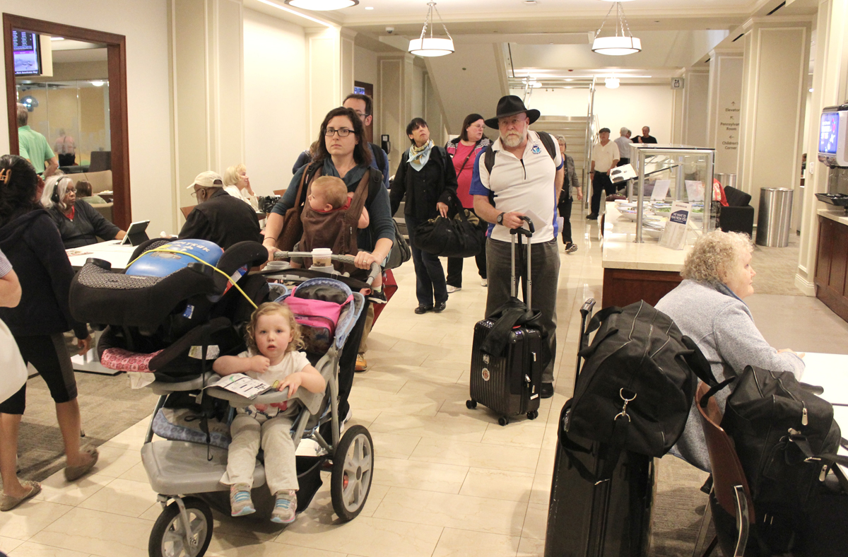 People in well-lit room at passenger station