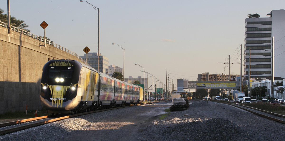 Passenger train with station in background