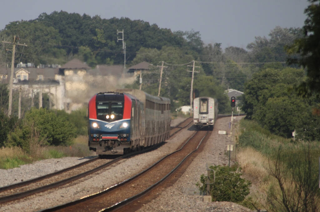 Two passenger trains meeting on straight track