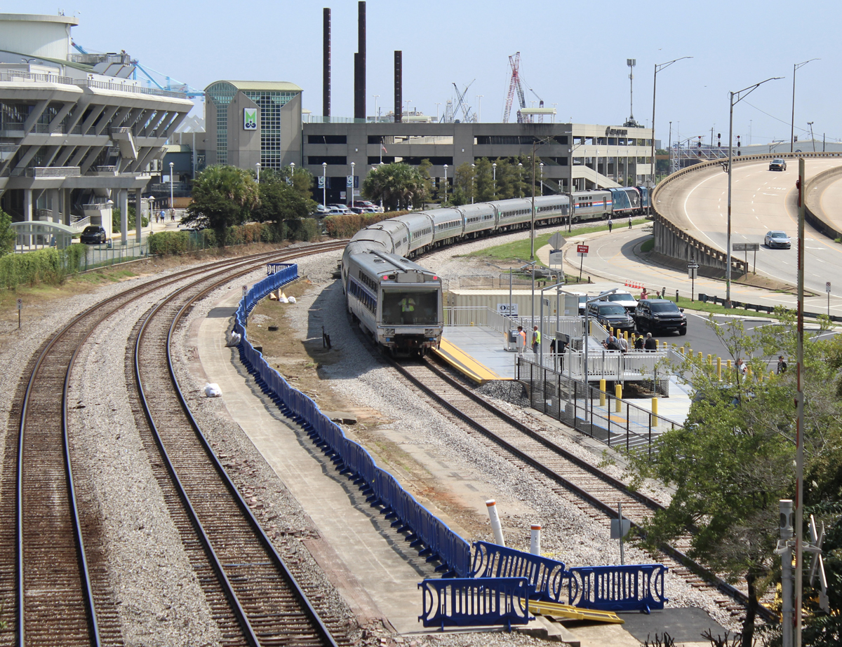 Passenger train on curve at station platform. Aug. 16, 2025