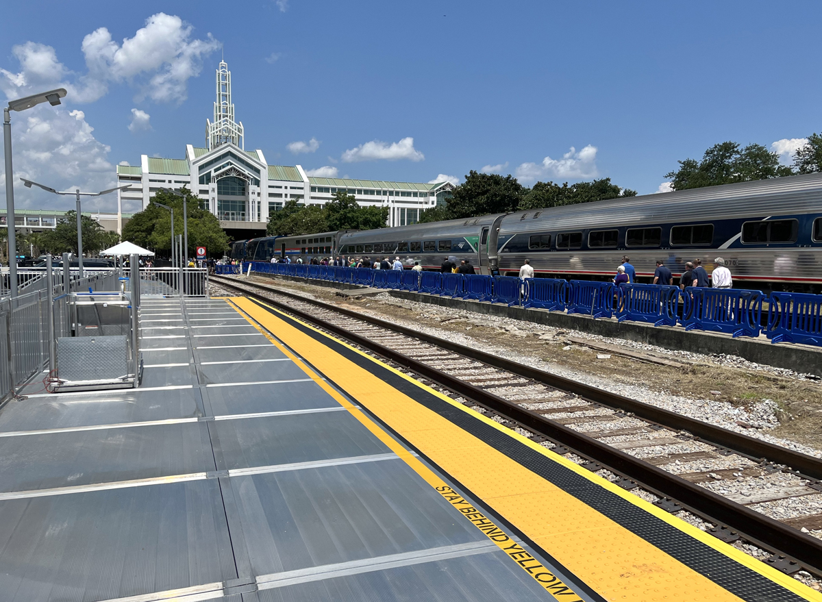 Empty station platform with passenger train in background. Aug. 16, 2025