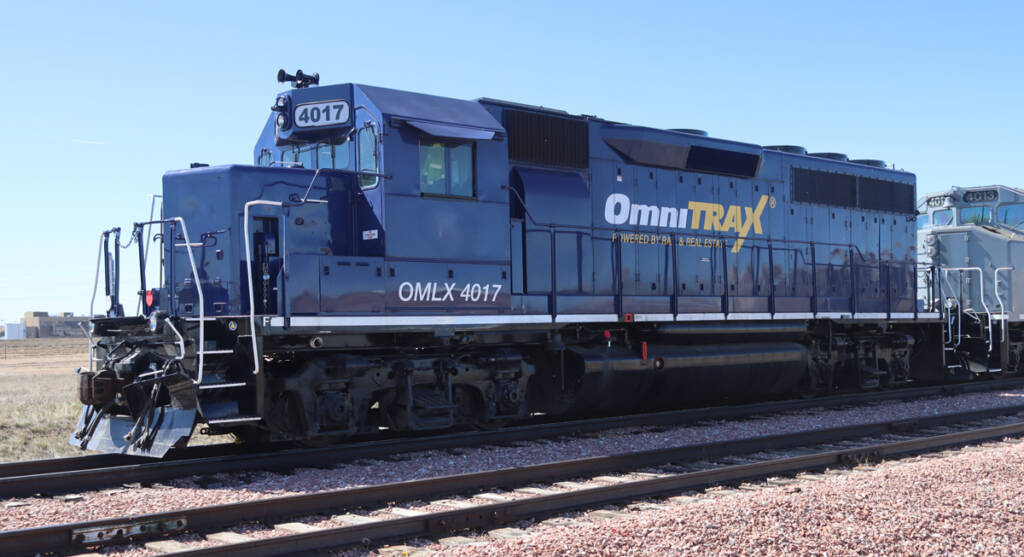 Side view of blue locomotive with OmniTrax lettering
