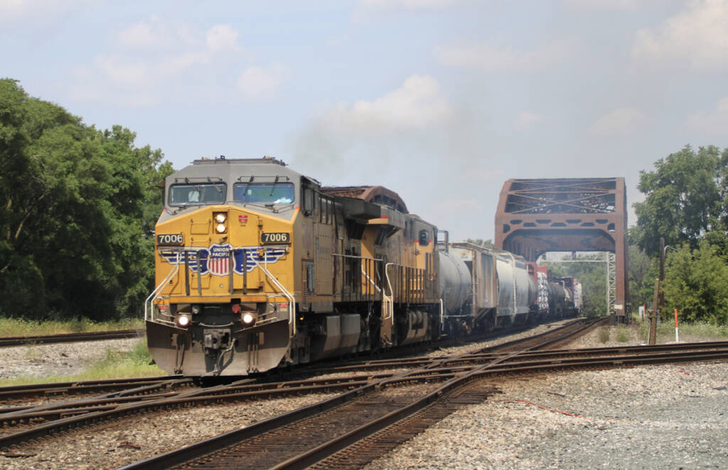 Freight train crossing diamond after crossing bridge